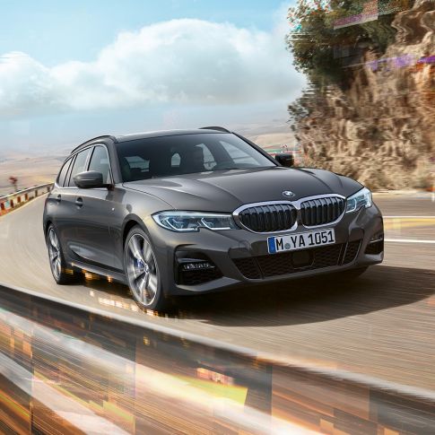 BMW Serie 3 Touring, ripresa anteriore del design BMW Serie 3 Touring, vista anteriore a tre quarti mentre attraversa un ponte rurale