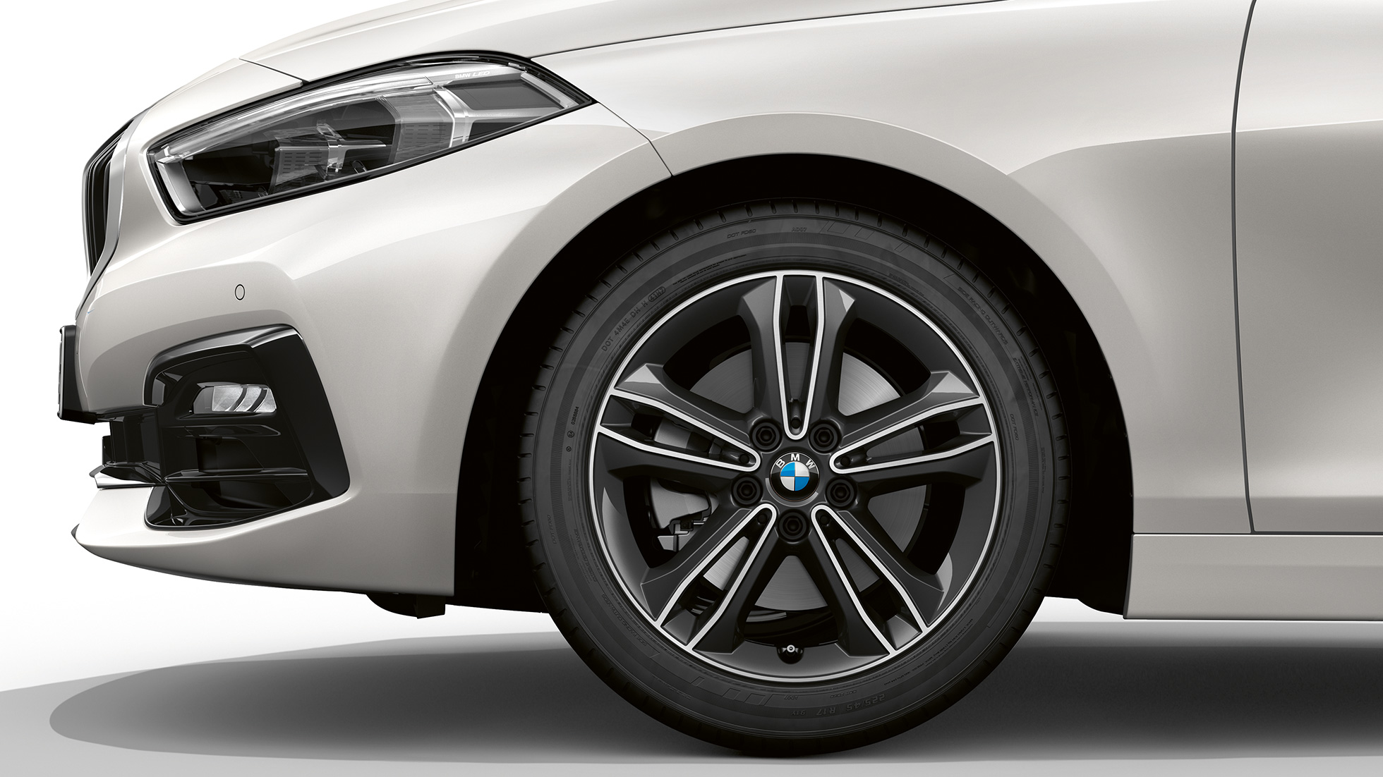 Cerchio in lega leggera da 17" styling a doppi raggi nº 549 F40. BMW Serie 1, Versione Sport in Mineral White metallizzato, vista laterale/frontale con cerchio in lega leggera da 17”, styling a doppi raggi n° 549 F40.