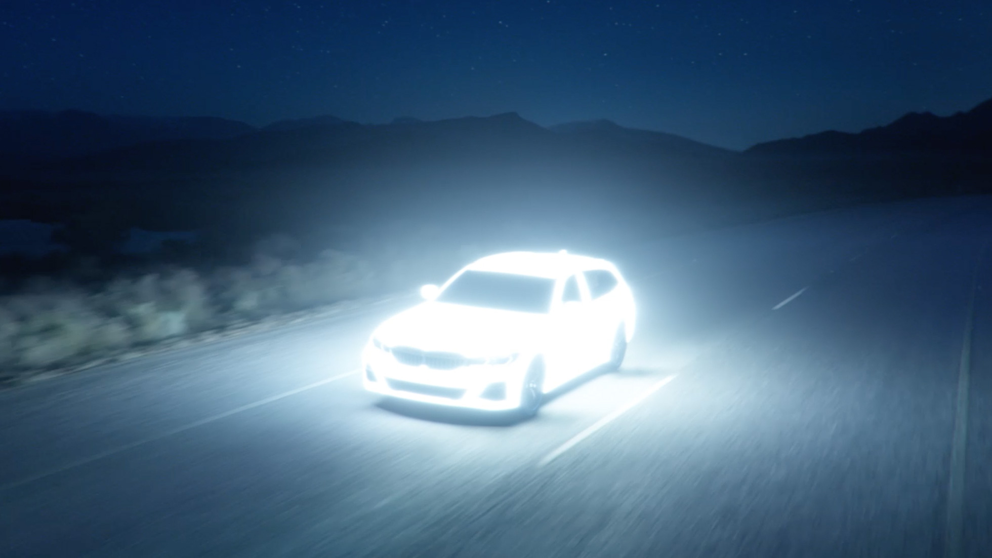 BMW Serie 3 Touring ibrida Plug-in G21 Vista anteriore a tre quarti BMW Serie 3 Touring ibrida Plug-in G21 Vi Vista anteriore a tre quarti in movimento di notte