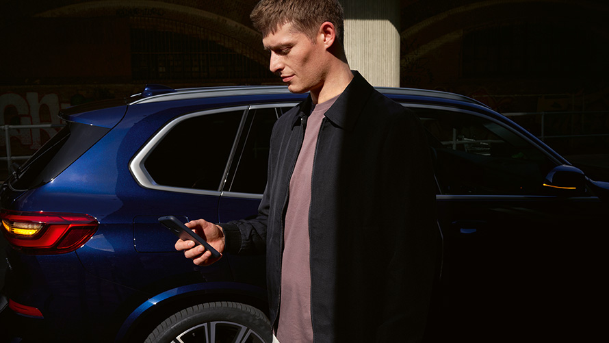 BMW Digital Key, per fino a 5 utenti La BMW Digital Key permette di registrare fino a 5 utenti Uomo con smartphone davanti alla BMW X5